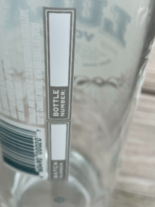 Liquor bottle with screen printed writable panel